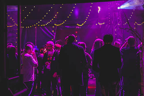 purple lighting and a croud of people